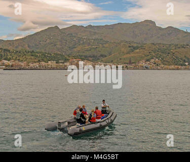 Giardini Naxos, Sicily, Italy. 12th Oct, 2004. A Zodiac inflatable boat with cruise ship passengers heads for the resort town of Giardini Naxos, on the east coast of Sicily. Taormina town sits above it atop the rocky peninsula overlooking Naxos Bay and the Ionian Sea, a popular tourist destination. Credit: Arnold Drapkin/ZUMA Wire/Alamy Live News Stock Photo