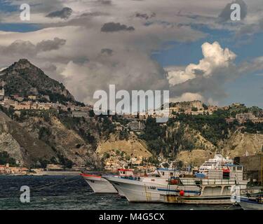 Giardini Naxos, Sicily, Italy. 12th Oct, 2004. Fishing boats sit in the harbor of the resort town of Giardini Naxos, on the east coast of Sicily. Taormina town sits above it atop the rocky peninsula overlooking Naxos Bay and the Ionian Sea. Sicily has become a popular tourist destination. Credit: Arnold Drapkin/ZUMA Wire/Alamy Live News Stock Photo