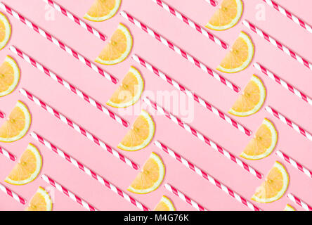 Pattern of lemon slices and straws  on light pink background. Funny lemonade concept Stock Photo