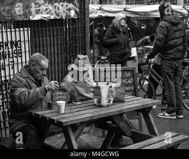 Black & White Photograph of two men in Brick Lane, London, England, UK. Credit: London Snapper Stock Photo