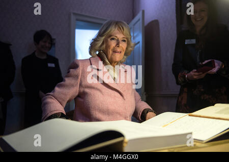 The Duchess of Cornwall copies out the final sentence of Wuthering Heights into a manuscript created by artist Clare Twomey, during a visit to the Bronte Museum in Haworth, Keighley. Stock Photo
