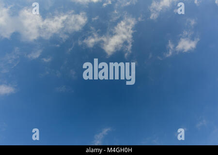 white fluffy clouds float on the blue sky on a bright  summer day Stock Photo