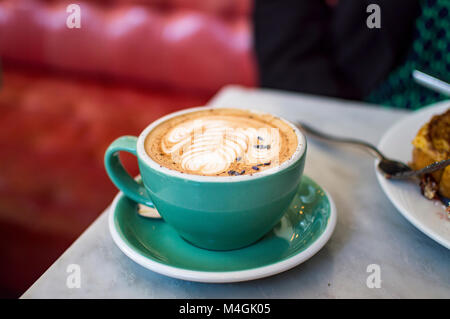 Mocha in green mug in cafe Stock Photo