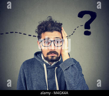 Young hipster man having question in mind and looking puzzled at camera. Stock Photo