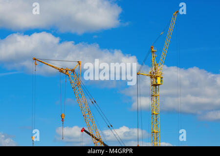 Two yellow construction cranes Stock Photo