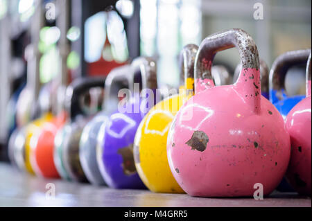 colorful kettlebells in a row in a gym Stock Photo