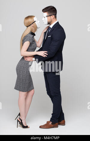 Man and woman in mask hiding real personality in front of each other concept Stock Photo
