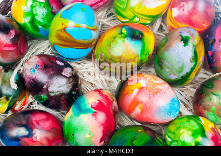 Colorful Easter eggs on natural yellow straw Stock Photo