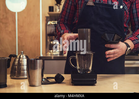 Barista brewing aeropress coffee Stock Photo