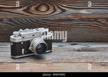Vintage old retro rangefinder camera on wooden background Stock Photo