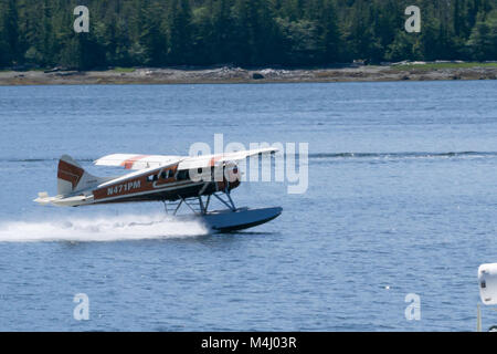 Single Prop Airplane Pontoon Plane flying in alaska mountains Stock Photo