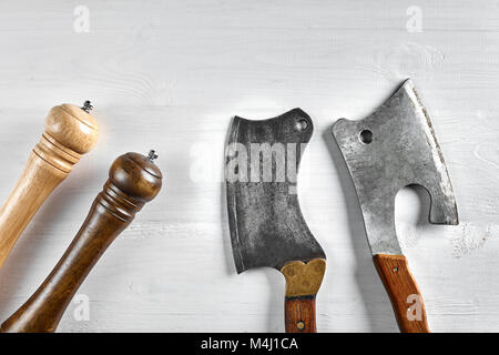 Kitchen ax, knife, cleaver, cutter with wooden handle. Axe on light background with spices. Ax for meat. Vintage. Top view. Copy space. Still life. Fl Stock Photo