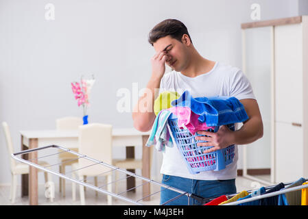 Man doing laundry at home Stock Photo