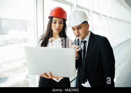 Group of engineer man and woman on construction site for check out the new project with laptop. Stock Photo