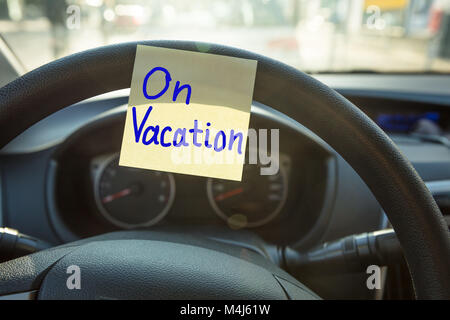 Close-up Of A Vacation Concept Written On Steering Wheel Of A Car Stock Photo