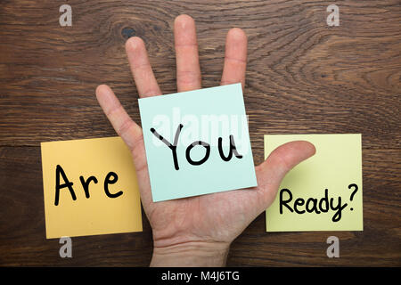 Are You Ready Concept Written On Stick Note At Wooden Desk Stock Photo