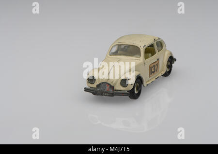 A white vintage 1500 saloon Volkswagen beetle toy race car car showing signs of use on a white background. Stock Photo