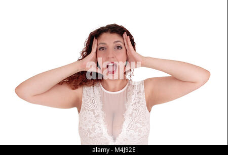 Woman shouting, hands on head. Stock Photo