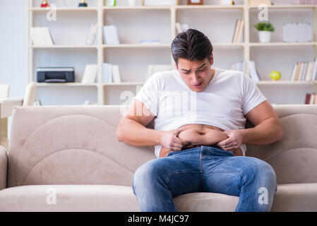 Man suffering from extra weight in diet concept Stock Photo