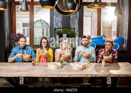 Group of people during the dinner at the asian food restaurant Stock Photo