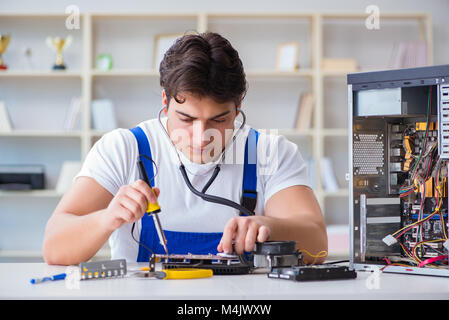 Computer repairman repairing desktop computer Stock Photo