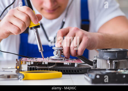 Computer repairman repairing desktop computer Stock Photo