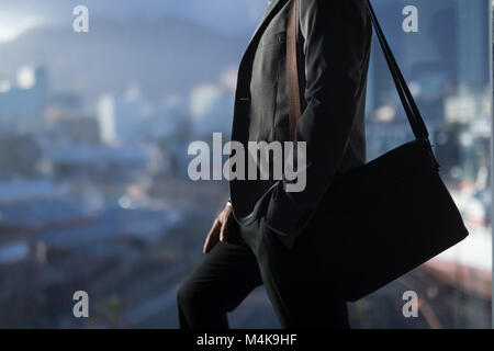 Business man standing with a bag Stock Photo