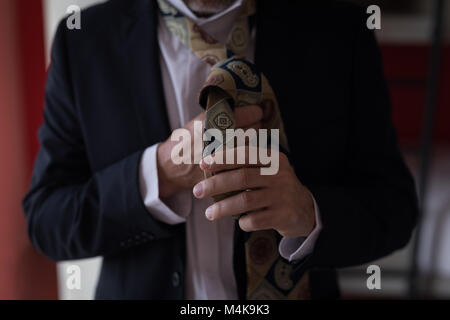 Businessman tying his tie Stock Photo