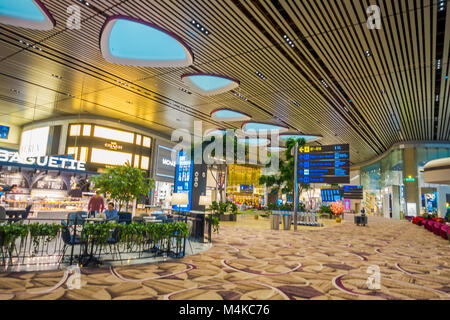 SINGAPORE, SINGAPORE - JANUARY 30, 2018: Gorgeous indoor view of unidentified people waiting in a foodhall area inside of Changi international airport Stock Photo