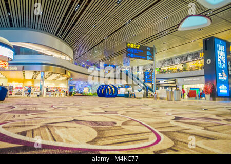 SINGAPORE, SINGAPORE - JANUARY 30, 2018: Gorgeous indoor view of unidentified people waiting in a foodhall area inside of Changi international airport Stock Photo