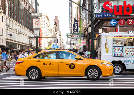 NEW YORK CITY - JUNE 24, 2017: Street scene from midtown Manhattan New York City with pedestrians and traffic seen from Herald Square. Stock Photo