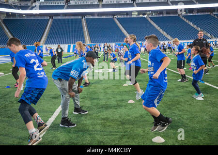 Detroit, Michigan - Detroit Lions linebacker Tahir Whitehead runs students through football drills during a physical activity and nutrition program at Stock Photo