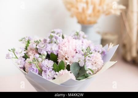 flower shop concept. Close-up beautiful lovely bouquet of mixed flowers on wooden table. Wallpaper Stock Photo