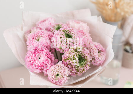 Persian buttercup. lace with many petals. Bunch pale pink ranunculus flowers light background. Wallpaper