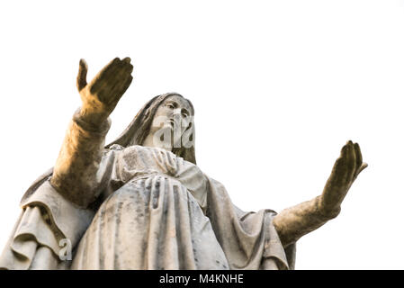 Statue of Our Lady on white background with open arms, seen from below. Concept and symbol of peace, religion, hope, mercy and faith Stock Photo