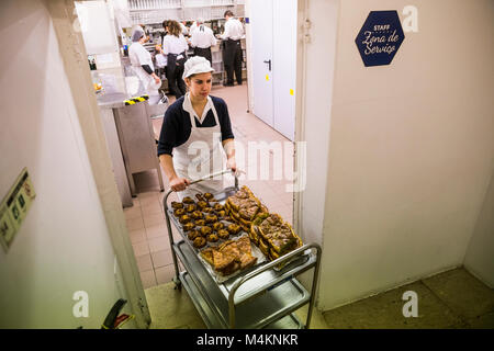 A cook moving pastries at Pasteis de Belem in Lisbon, Portugal. Stock Photo