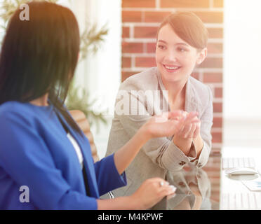 Two young businesswomen having meeting at office Stock Photo
