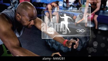 Athletic fit man in gym with health interface Stock Photo