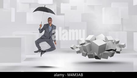 Man with umbrella floating next to geometric surreal cubes Stock Photo