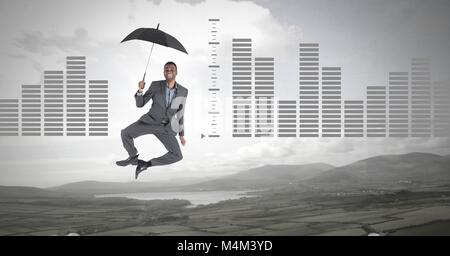 Man floating with umbrella and bar charts over nature landscape Stock Photo
