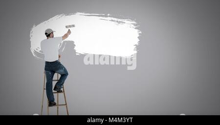 Man painting white on wall Stock Photo