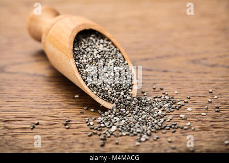 Raw Chia Seeds On Wooden Scoop On Wooden Background Stock Photo