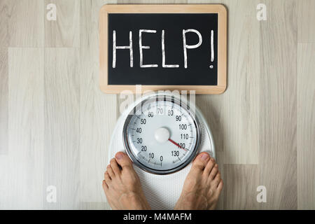 Closeup Of Man's Feet On Weight Scale Indicating Overweight Stock Photo,  Picture and Royalty Free Image. Image 33443183.