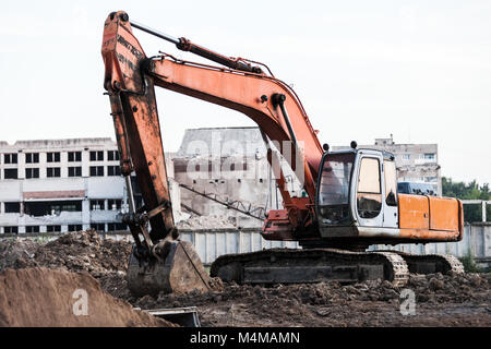 Digging excavator machine at building construction site Stock Photo