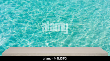 ocean transparent blue water defocus background with wooden shelf Stock Photo