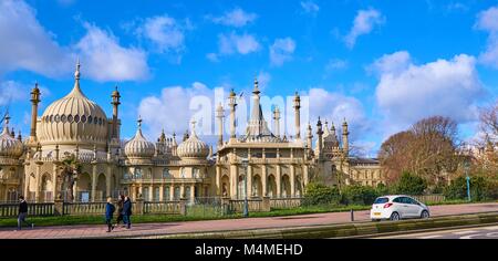 Brighton Royal Pavilion, Brighton, East Sussex, England on a clear sunny day, pedestrians walking by and a car Stock Photo