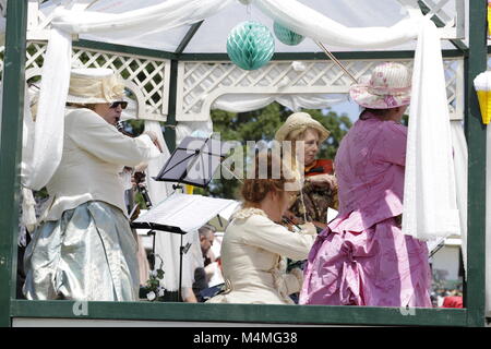 People in traditional clothes making music on a fair Stock Photo