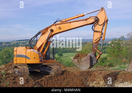 Excavator in action during earth moving works Stock Photo