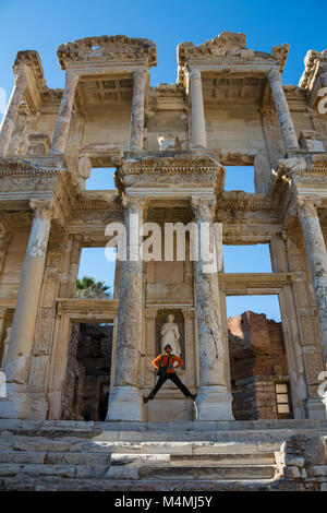 a tourist man is taking Ephesus Celsus Library's photo in a rainy day. Stock Photo