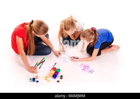Happy kids drawing isolated on white. Team work, creativity concept. Stock Photo